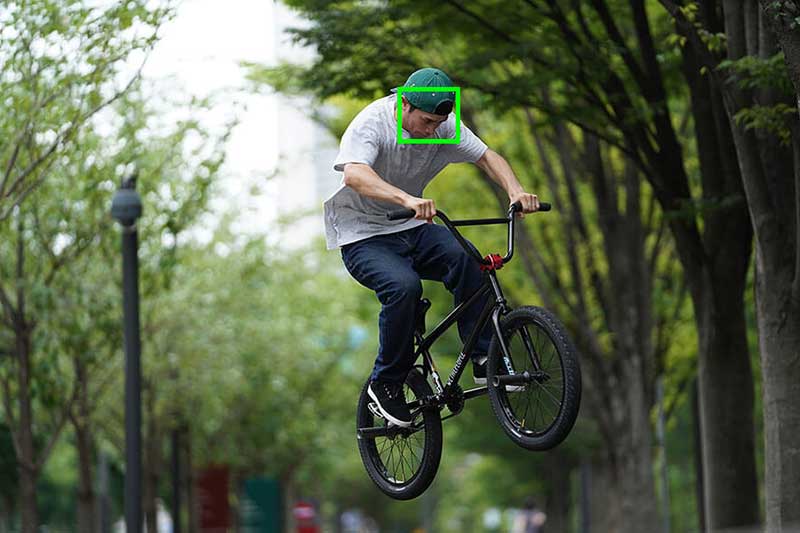 Image of bike in mid-jump, tracking activated on rider's face